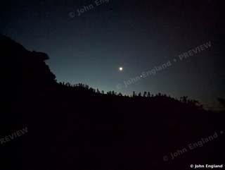 Crescent Moon and Planet – Crescent moon and bright planet over a treed ridge, Shasta Dam Blvd, Shasta Lake, CA.