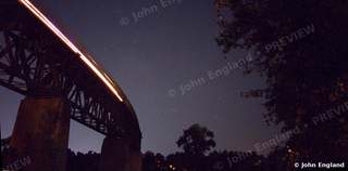 Train Light Trail Under the Big Dipper – Train light trail on the railroad bridge under the Big Dipper, Redding, CA, Jul 22, 2019.