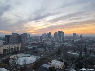 Pastel Dusk Skyline – Aerial dusk with pastel clouds over the downtown skyline.