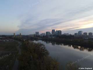 River Dusk Skyline – Aerial dusk view of the river curving toward the downtown skyline.