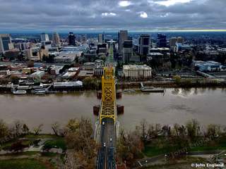 River, Bridge and Skyline, Aerial – Aerial view over the Sacramento River toward downtown Sacramento, CA. Dec 16, 2021. John England.